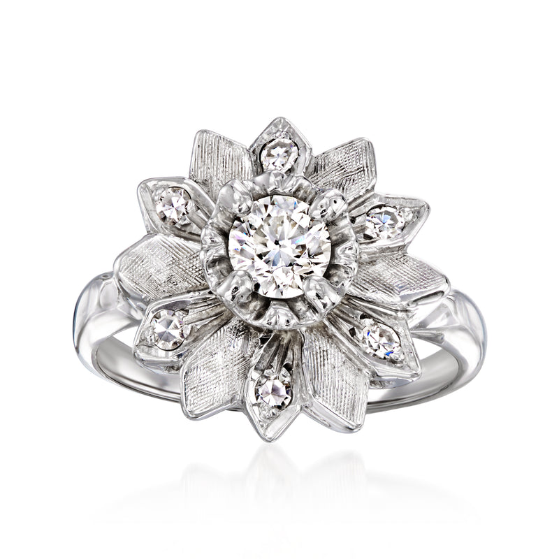 Vintage diamond flower ring in 14kt white gold with round center stone and small accents