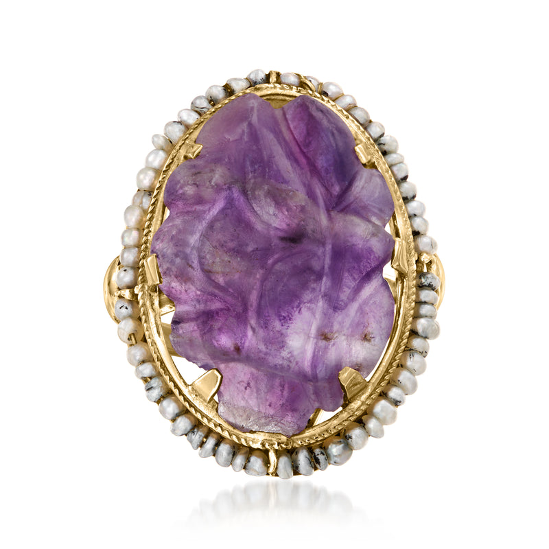 Oval purple amethyst cabochon ring with yellow gold prongs and pearl halo bezel