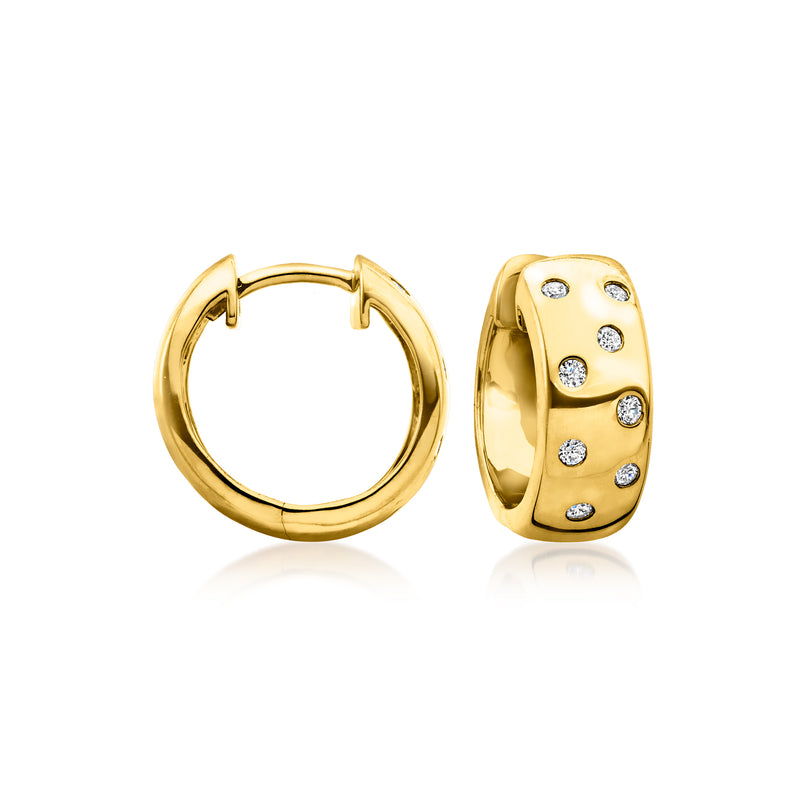 Gold huggie hoop earrings with small scattered round stones on the front