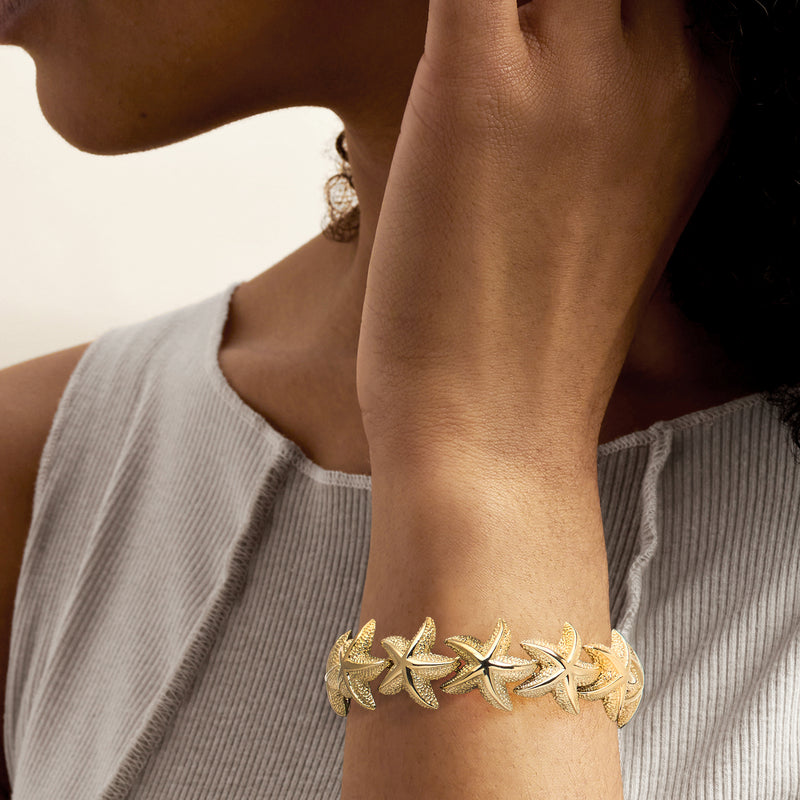 14k yellow gold starfish bracelet on wrist, clasp visible