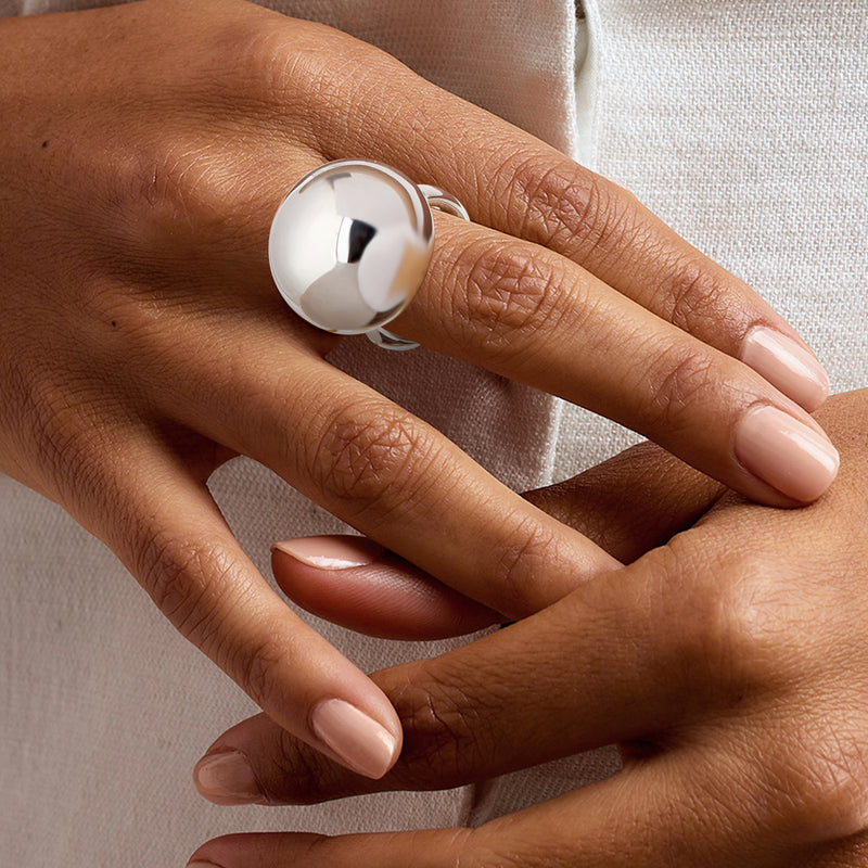 Sterling silver dome bead ring on finger, glossy round top