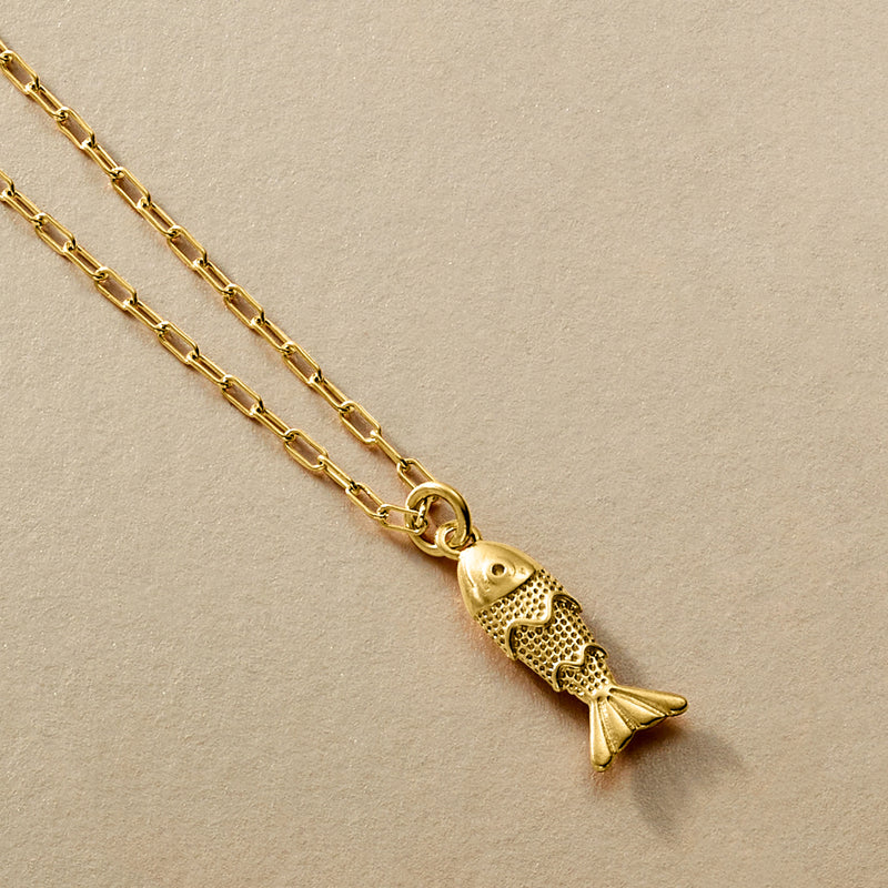 Gold fish pendant on a link chain with circular clasp detail
