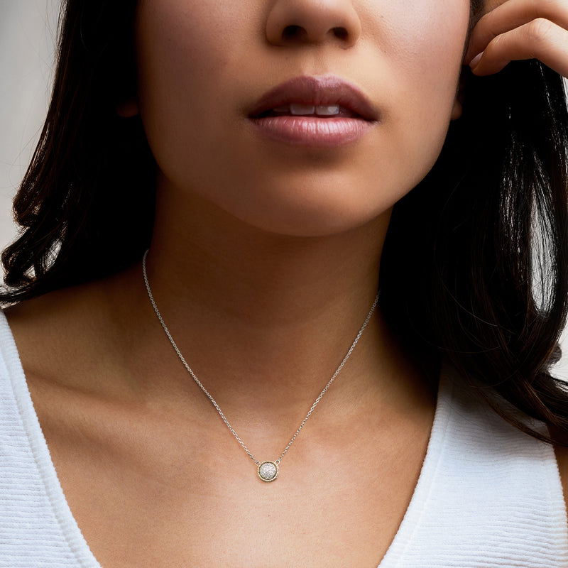 Diamond cluster necklace in sterling silver with small gold halo pendant