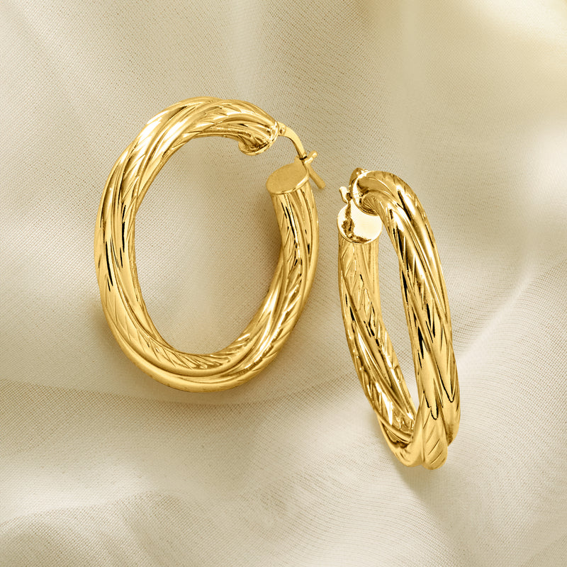 Twisted gold-plated hoop earrings, close-up of textured spiral wire and clasp.