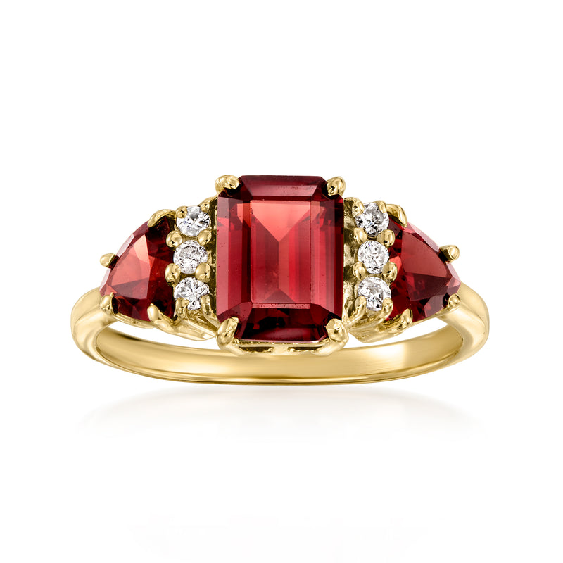 Vintage 14kt yellow gold garnet ring with emerald-cut center and diamond side clusters