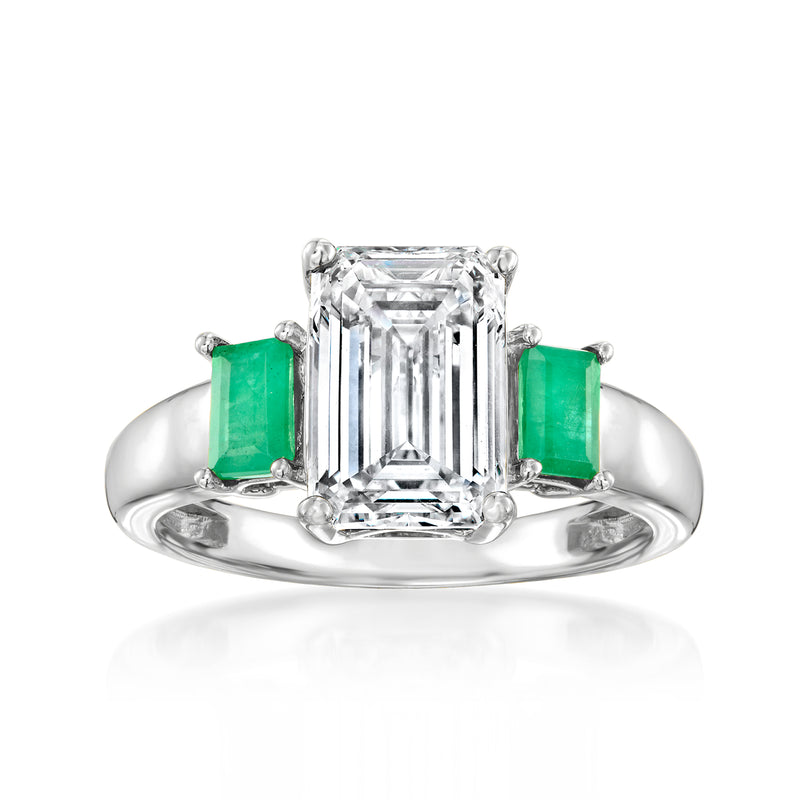 14kt white gold ring with emerald green side stones and a clear emerald-cut center diamond