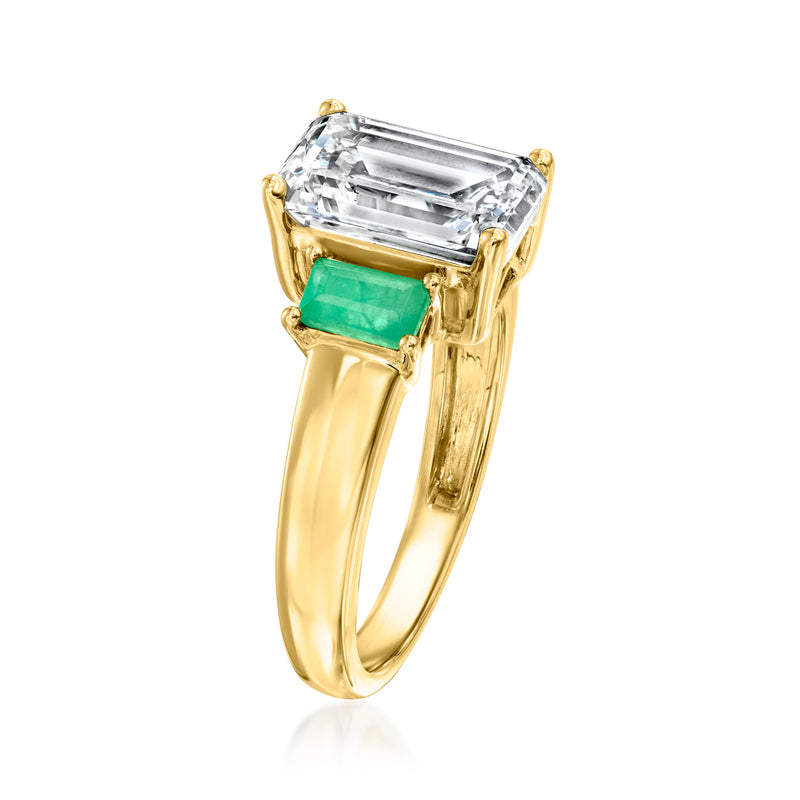 14kt yellow gold ring with emerald-green side stones and clear rectangular center diamond