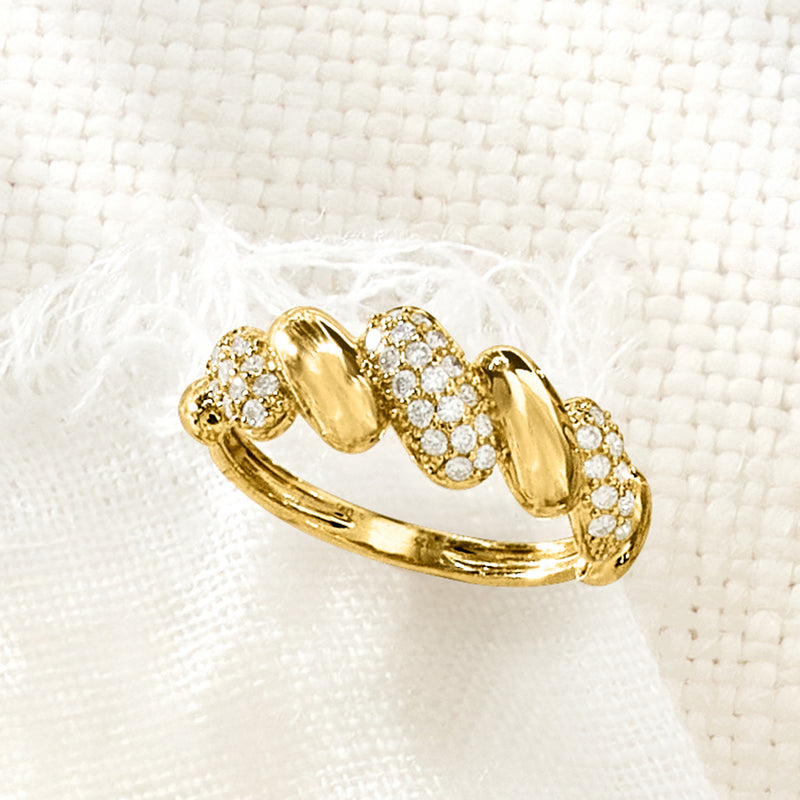 Close-up gold wave ring with round diamond clusters on puffy bands