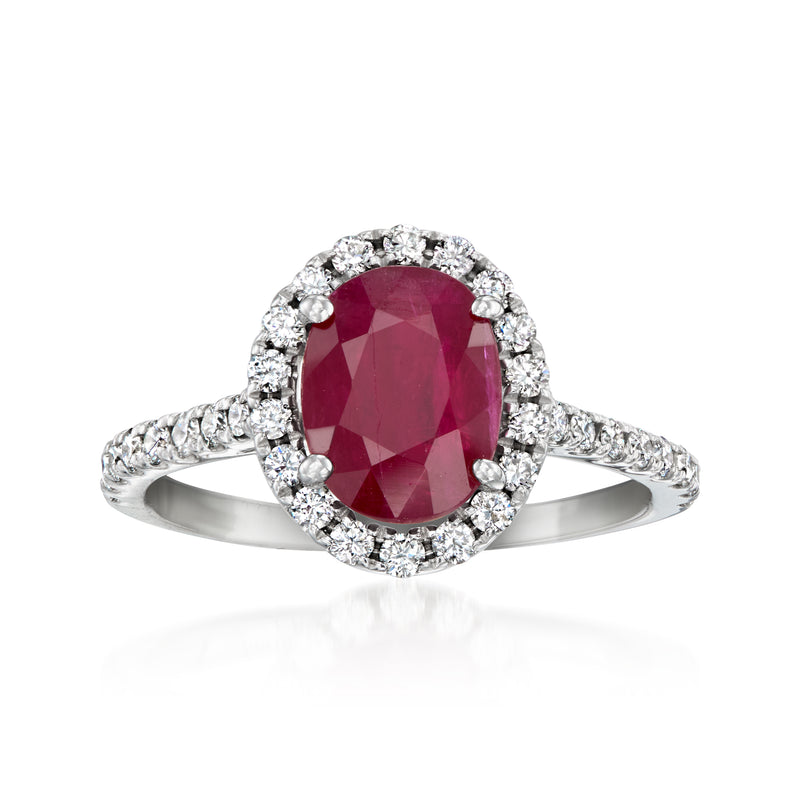 Vintage ruby ring with oval ruby, diamond halo, and diamond band in white gold