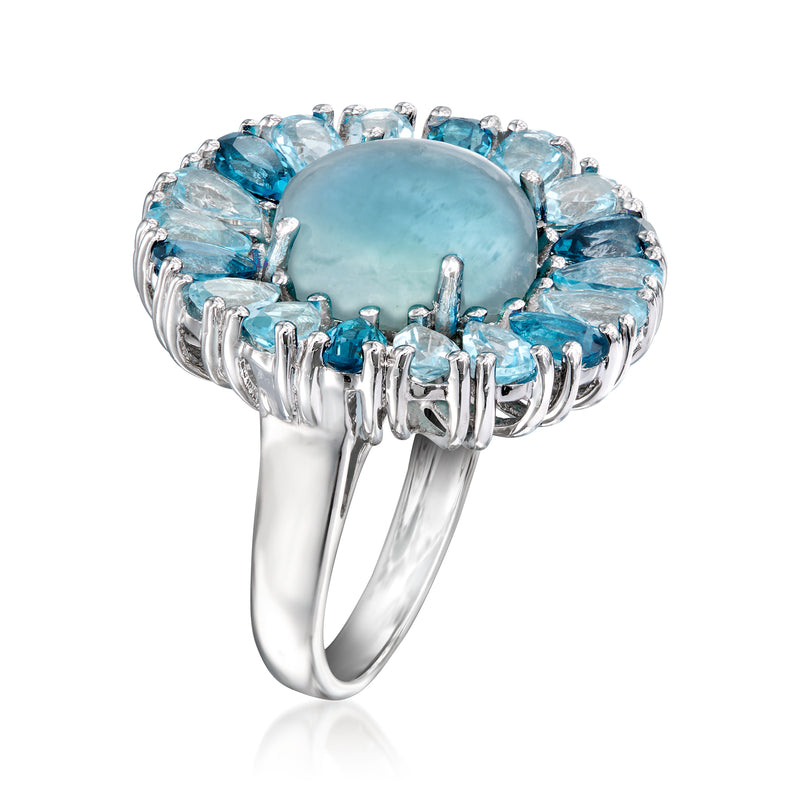 Sterling silver halo ring with milky blue oval center and detailed prongs