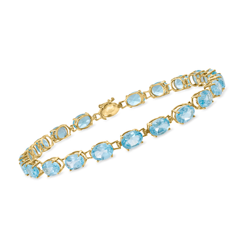 14kt yellow gold tennis bracelet with sky blue oval topaz gemstones, hinged links