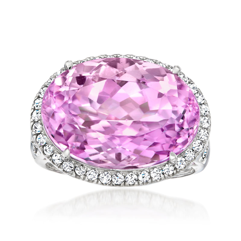 Pink oval kunzite ring with diamond halo and platinum band, round-cut side stones
