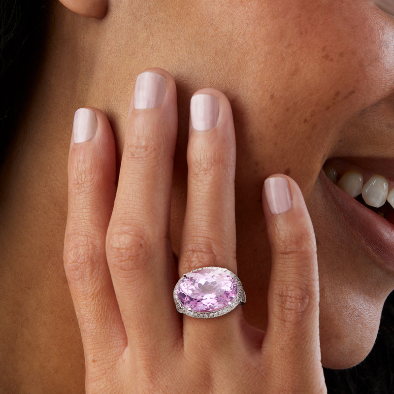 Pink oval kunzite ring on hand with light-pink nails