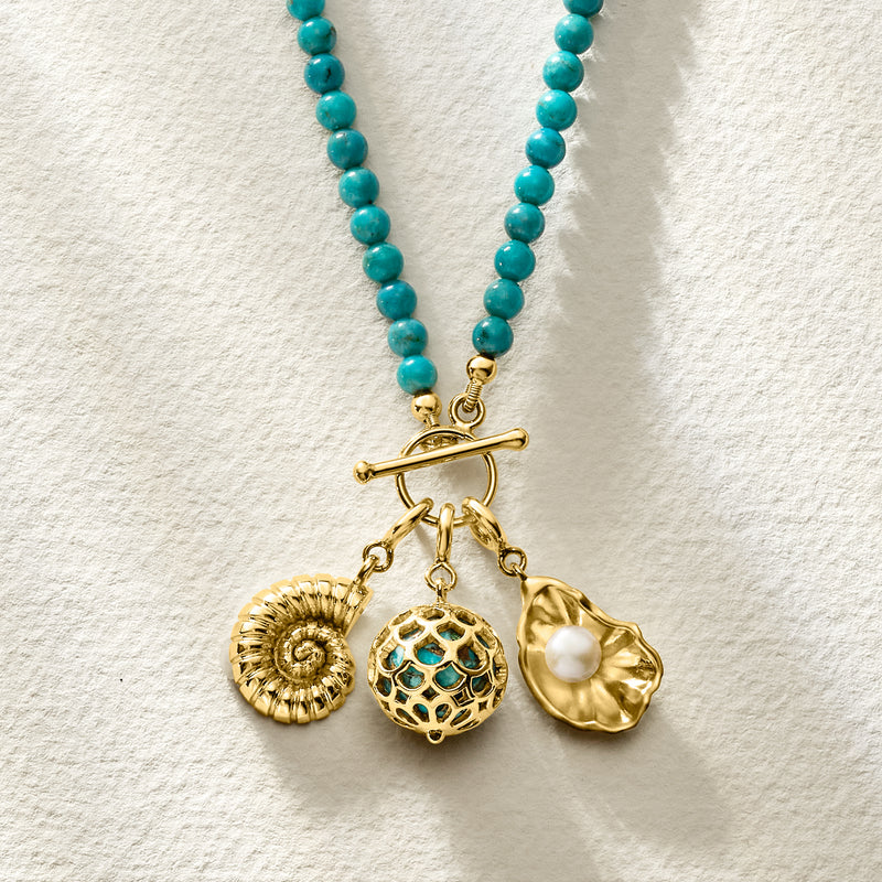 Turquoise beaded necklace with gold toggle and layered charm set with pearl