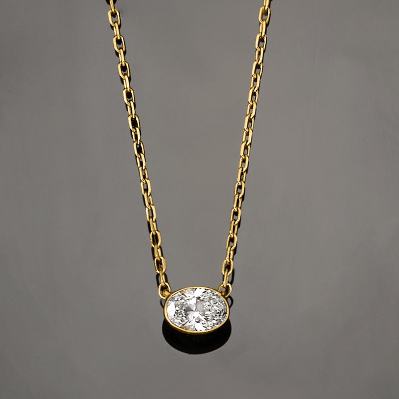 Gold lab-grown diamond pendant necklace with round-link chain, side view