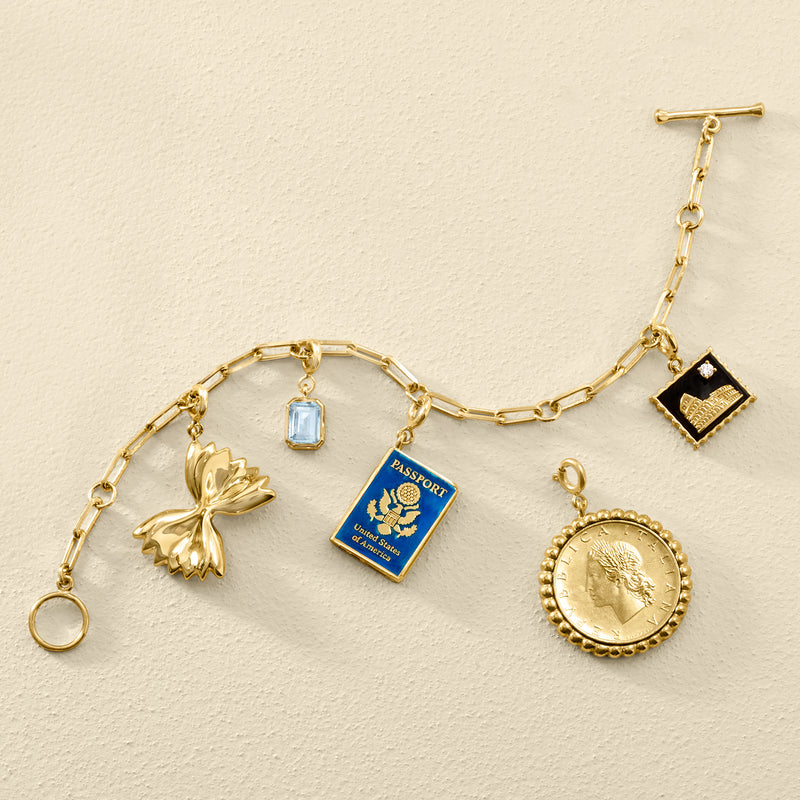 Gold charm bracelet with blue enamel passport charm pendant
