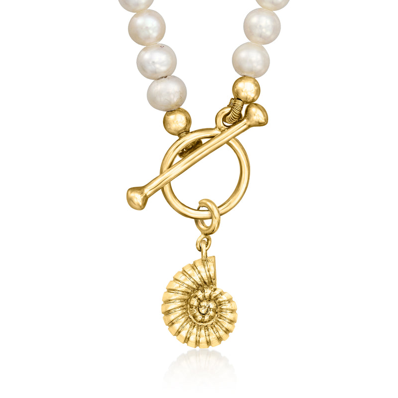 Gold nautilus seashell charm with sunburst ridges hanging from pearl beads