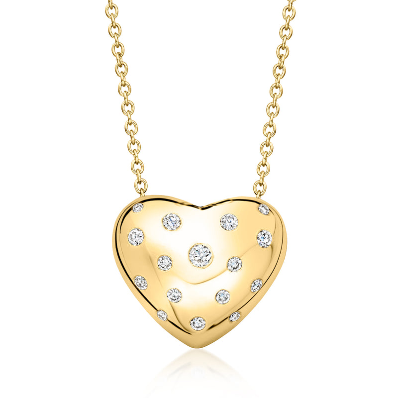 Gold heart pendant necklace with scattered round diamond-look stones on a dome setting