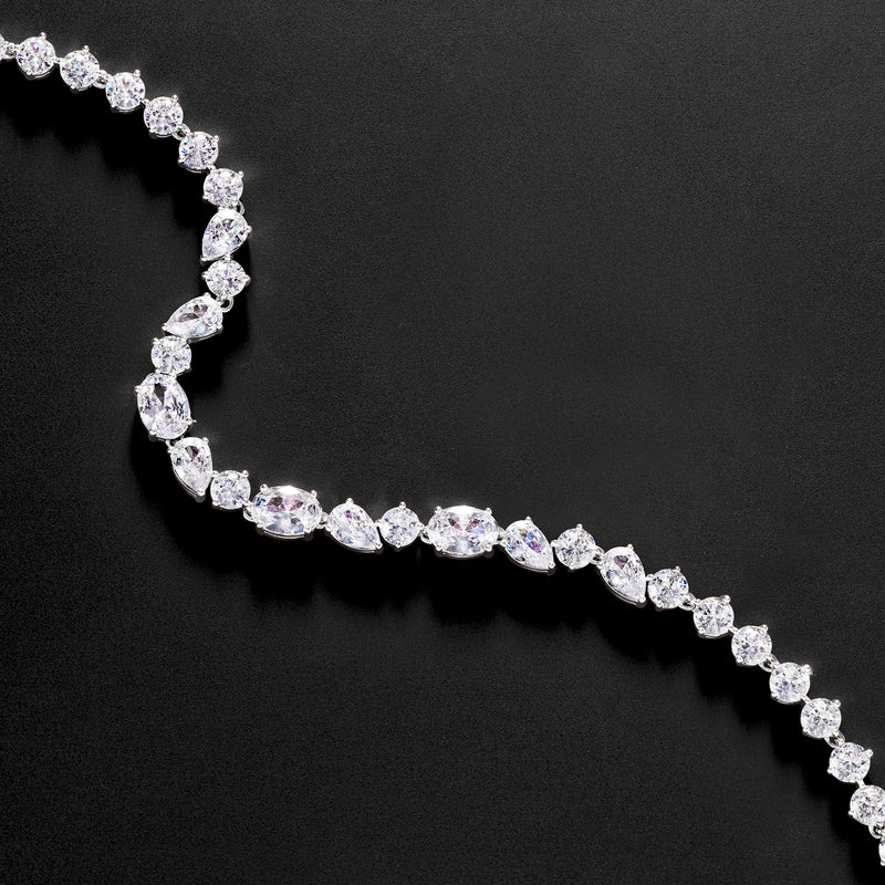 Rhodium-plated CZ bracelet with oval stones in a curved row and secure box clasp