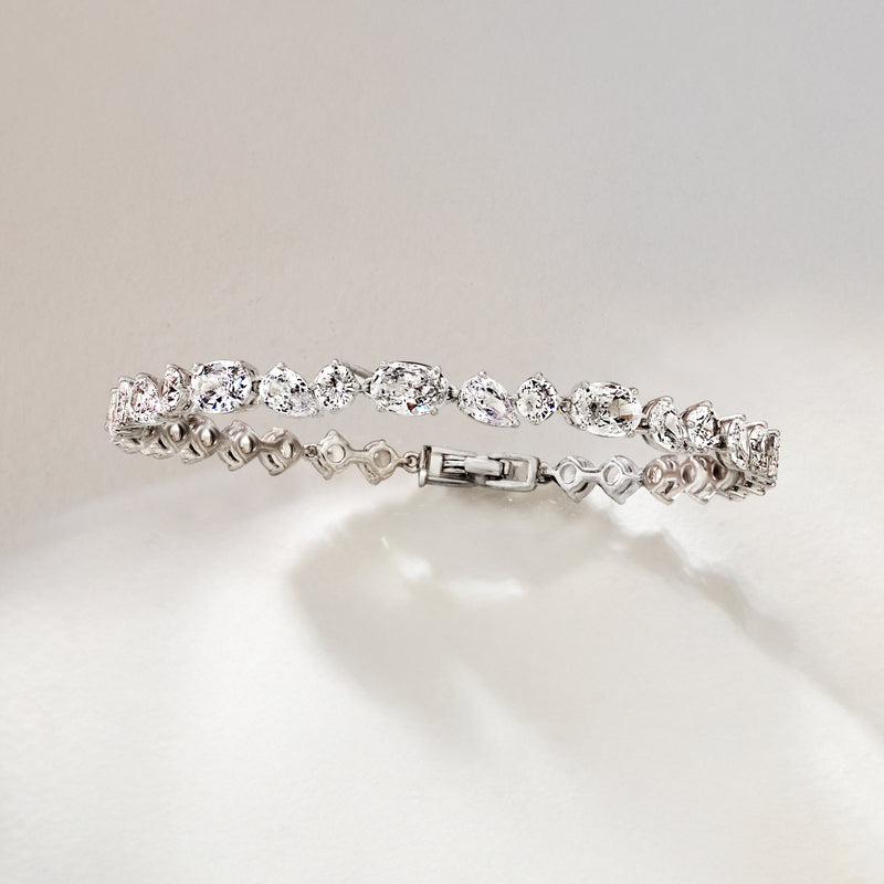 Rhodium-plated CZ bracelet with oval stones, decorative center links, box clasp