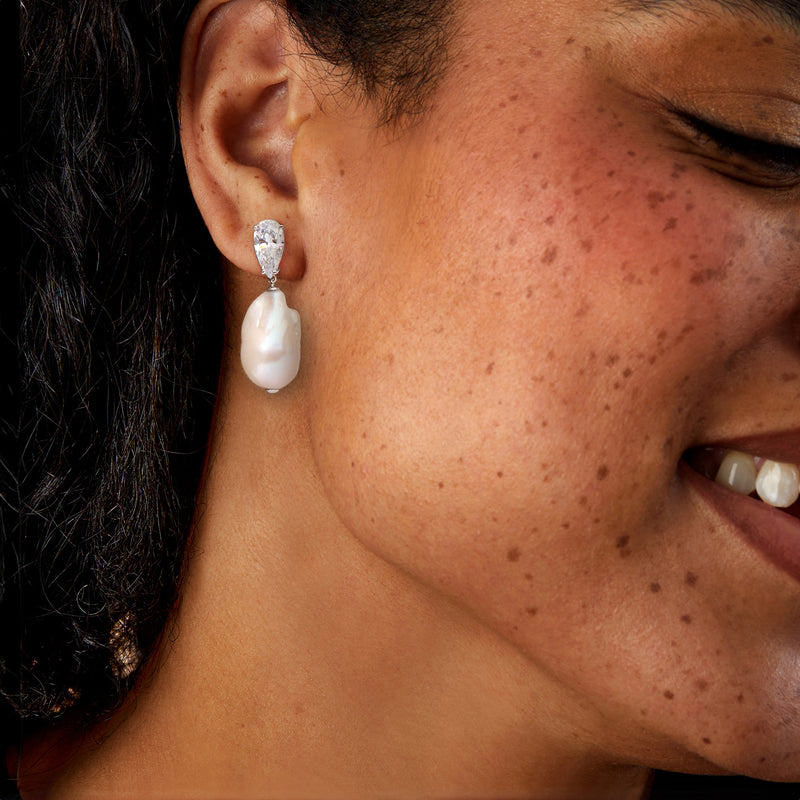 Rhodium-plated CZ and white baroque cultured pearl drop earrings worn