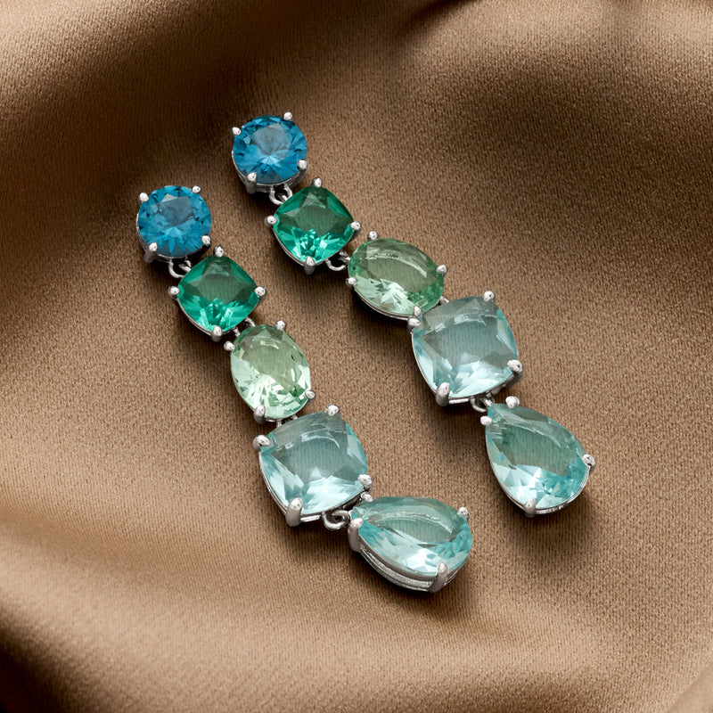 Linear drop earrings with alternating teal and blue simulated stones and rhodium settings