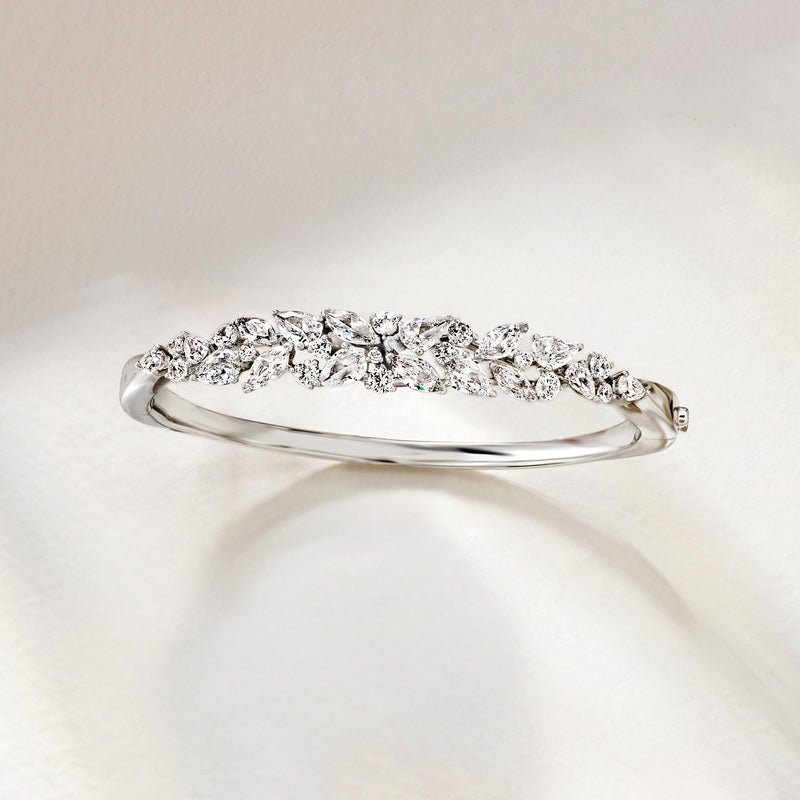 Rhodium-plated bangle bracelet with curved clear CZ cluster stones and clasp
