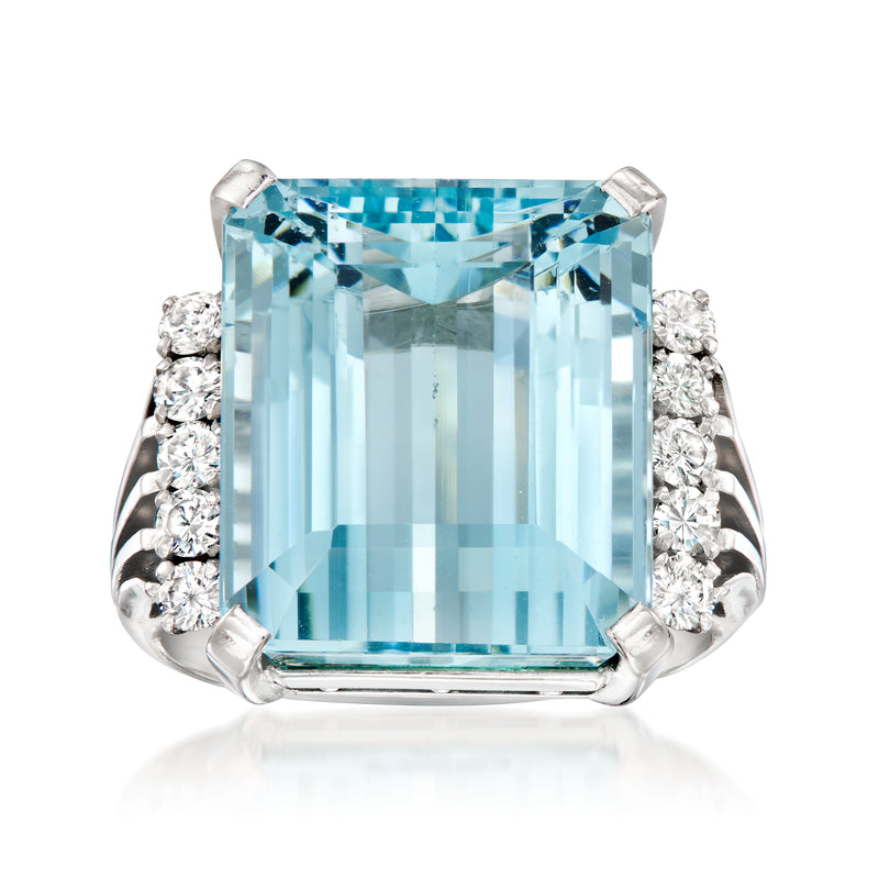 Platinum aquamarine ring with rectangular light-blue gemstone and diamond side clusters