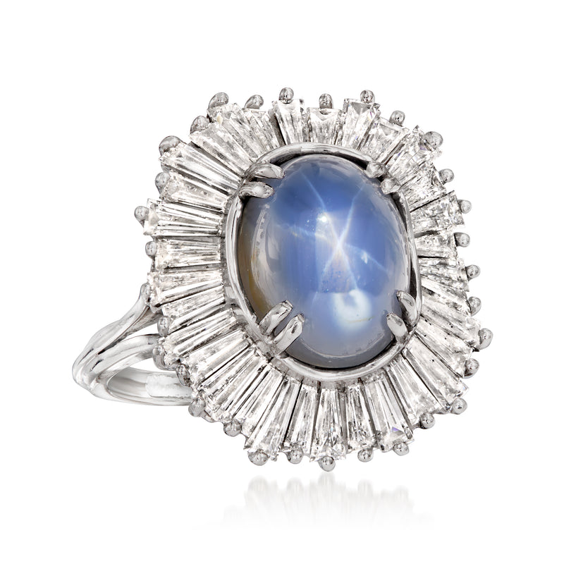 Platinum oval blue star sapphire ring with large diamond halo and scalloped side stones