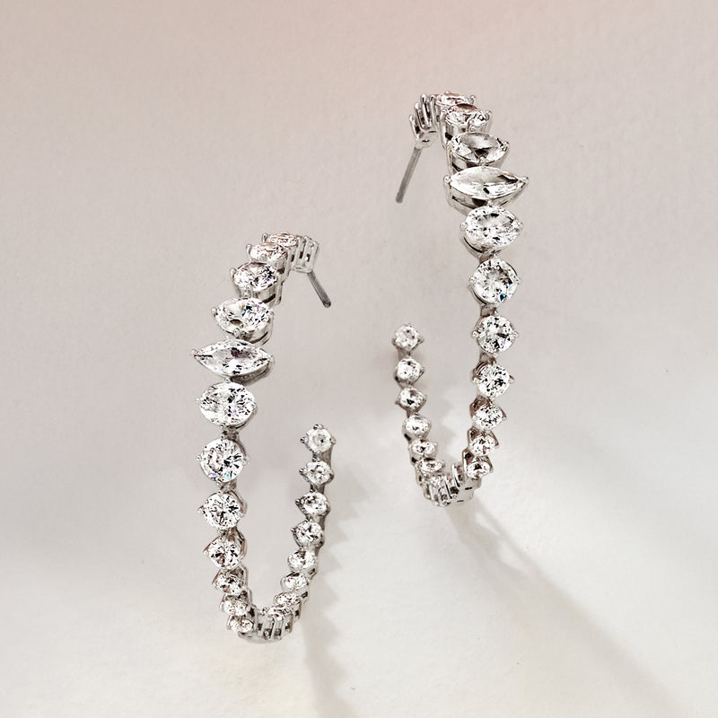 Rhodium-plated hoop earrings with clustered clear CZ stones on hinged hoops
