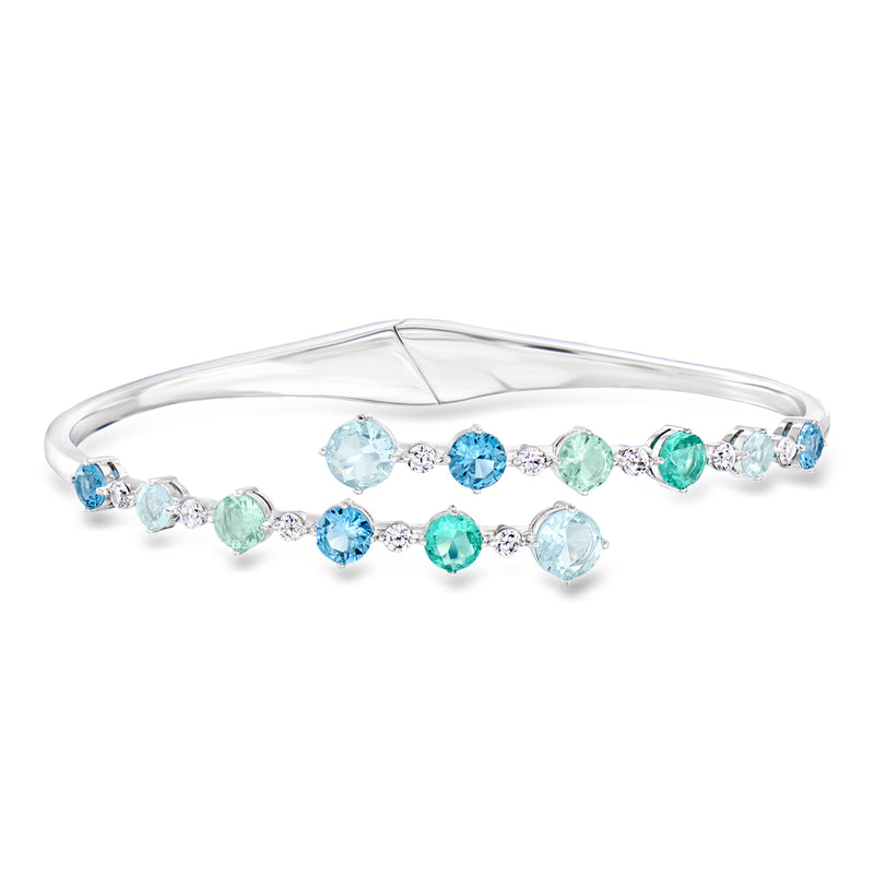 Rhodium-plated bypass bangle bracelet with blue and green simulated gemstones
