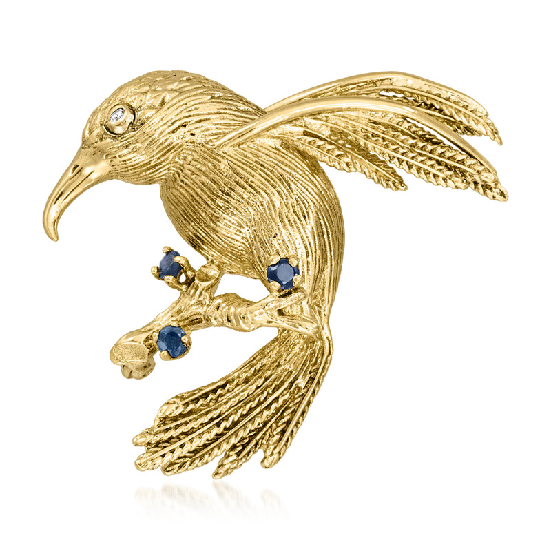 Gold hummingbird pin with sapphire blue stones and small diamond accents