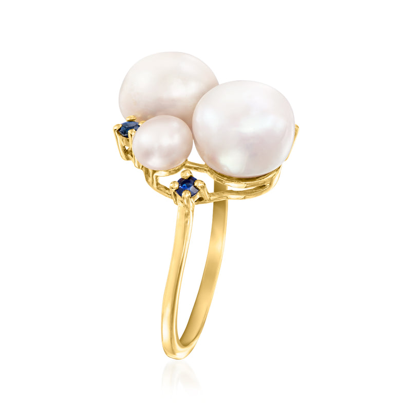 Gold-tone ring with three white pearls, blue sapphire details, slim band