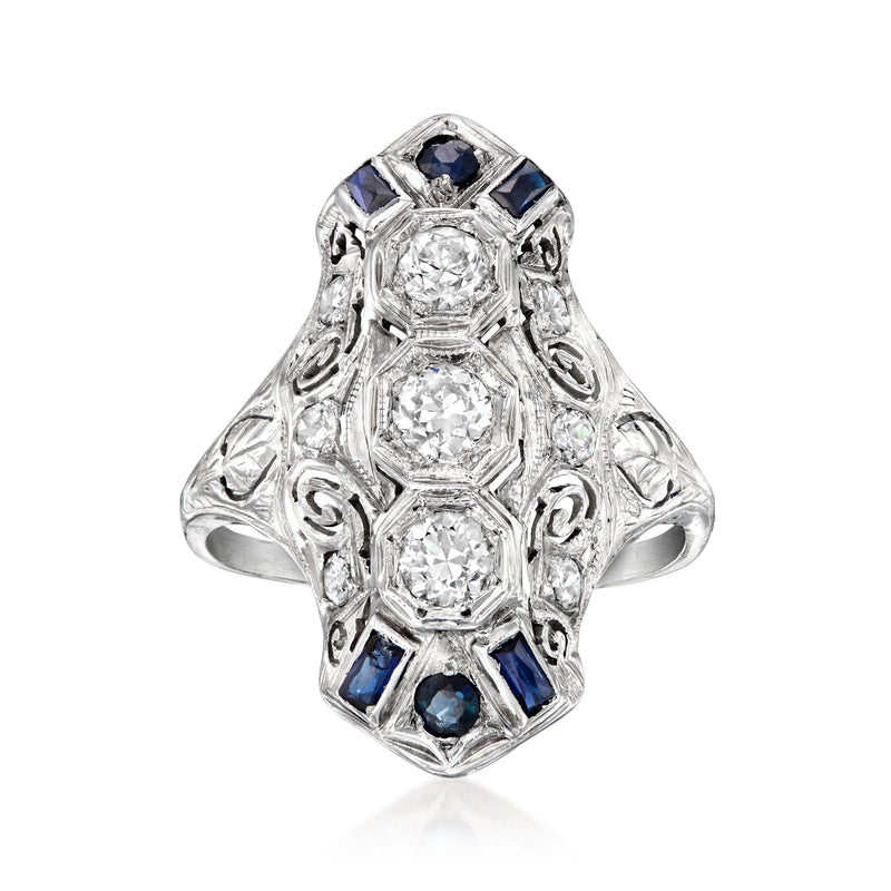 Vintage white gold ring with three faceted stones and blue sapphire accents, ornate setting