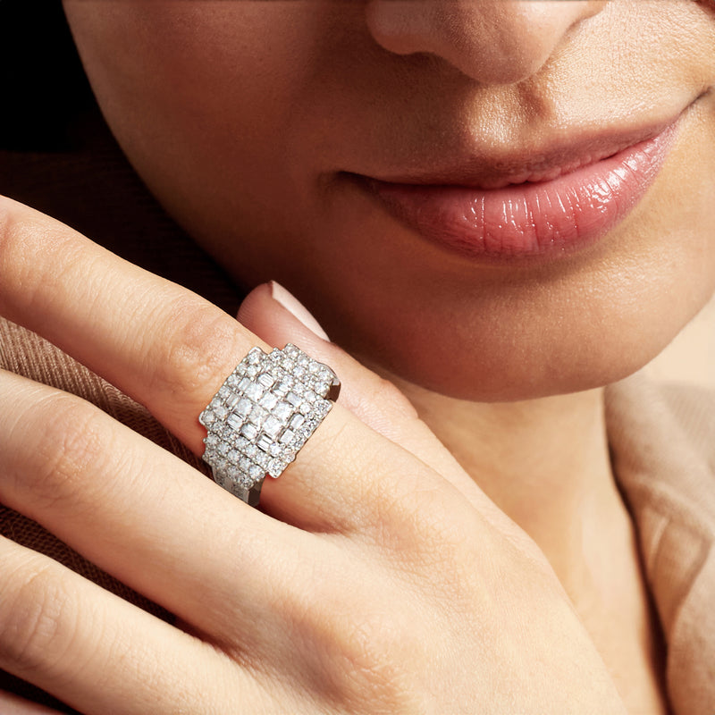 Vintage diamond cluster ring on finger, white gold with square-cut stones