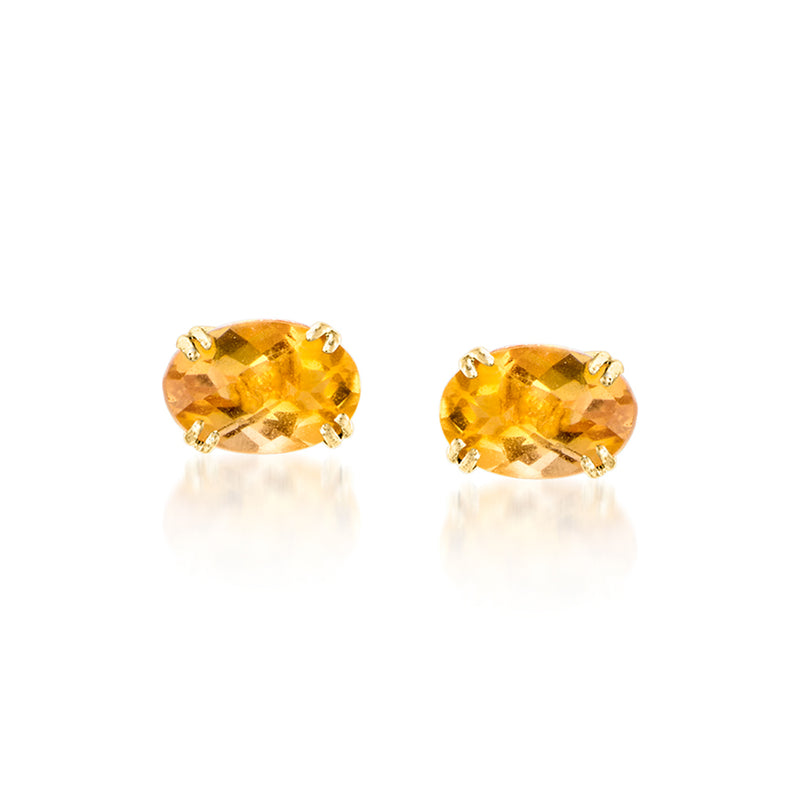 Pair of yellow gold earrings with oval citrine gemstones and faceted sparkle