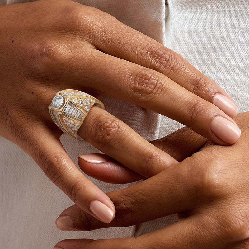14kt yellow gold diamond cocktail ring on hand, baguette and round stone design
