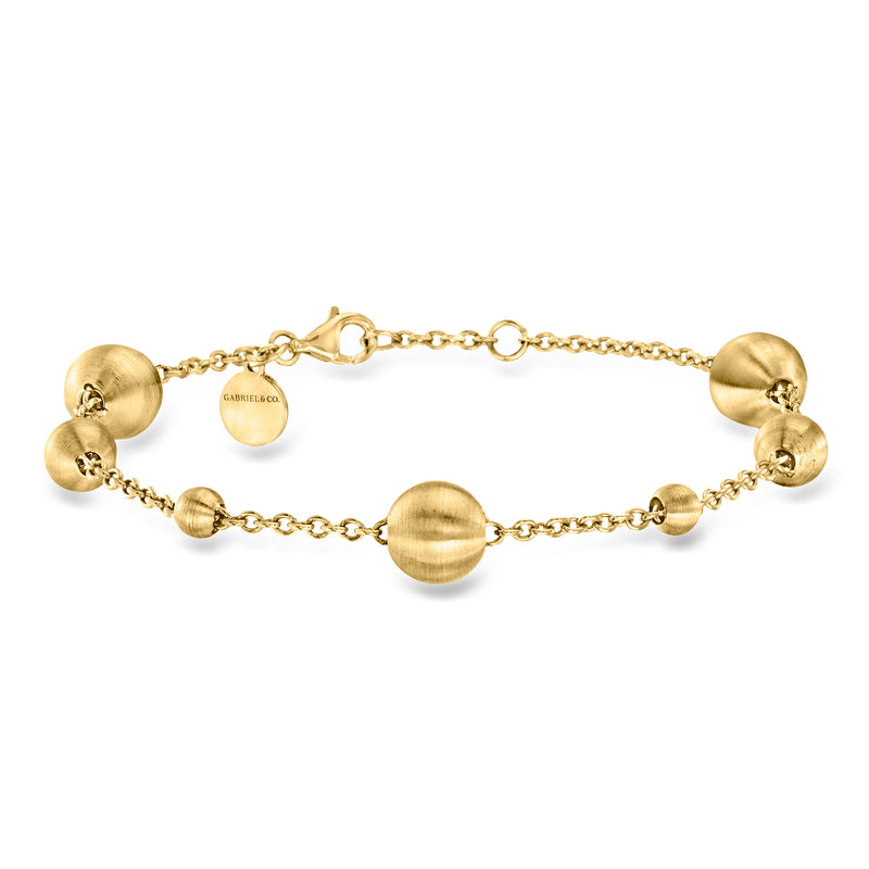 14kt yellow gold bead station bracelet with round bead stations and oval clasp