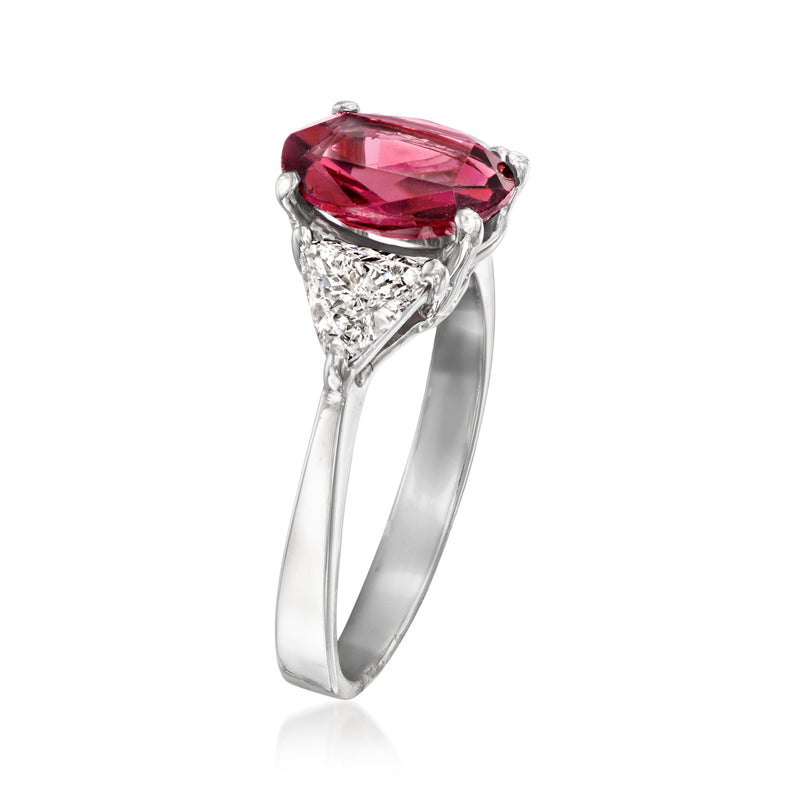 Platinum vintage ring with pink rhodolite oval center and diamond side clusters