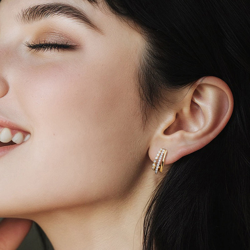 Curved three-row diamond hoop post earrings on ear, gold over sterling
