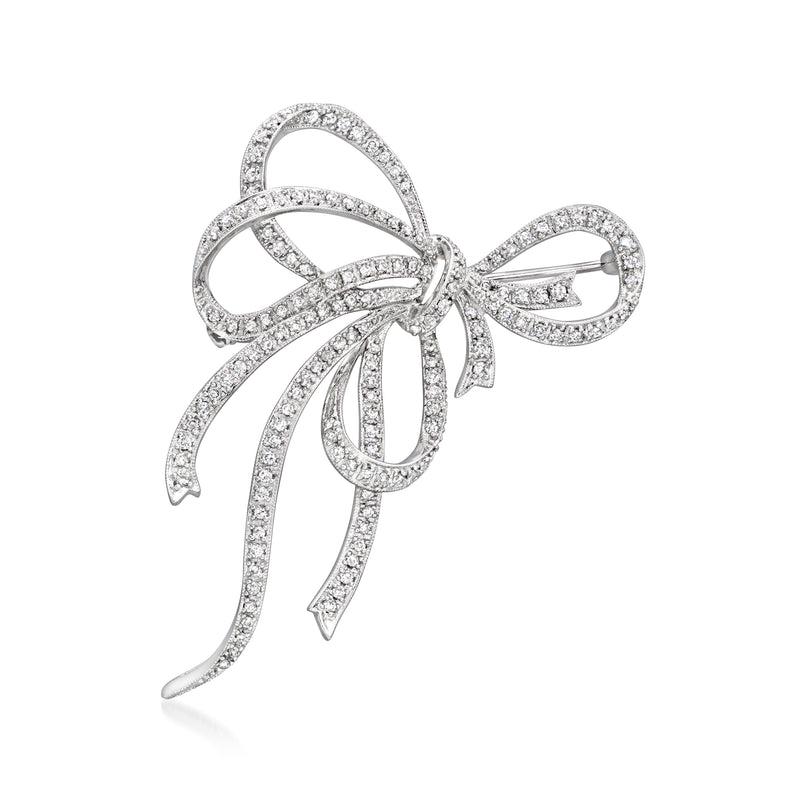 Diamond-studded bow pin in 18kt white gold with ribbon tails