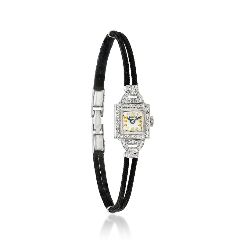 Vintage diamond watch with black cord strap, rectangular gold dial, platinum case