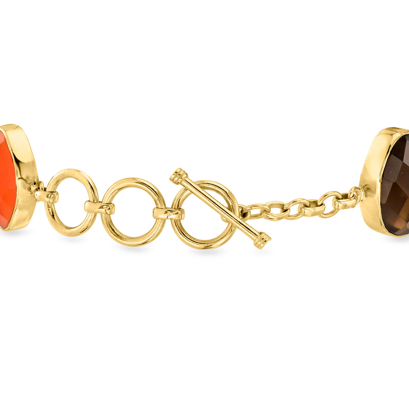 Gold-tone bracelet with oval cabochons and ring toggle clasp in red and smoky colors