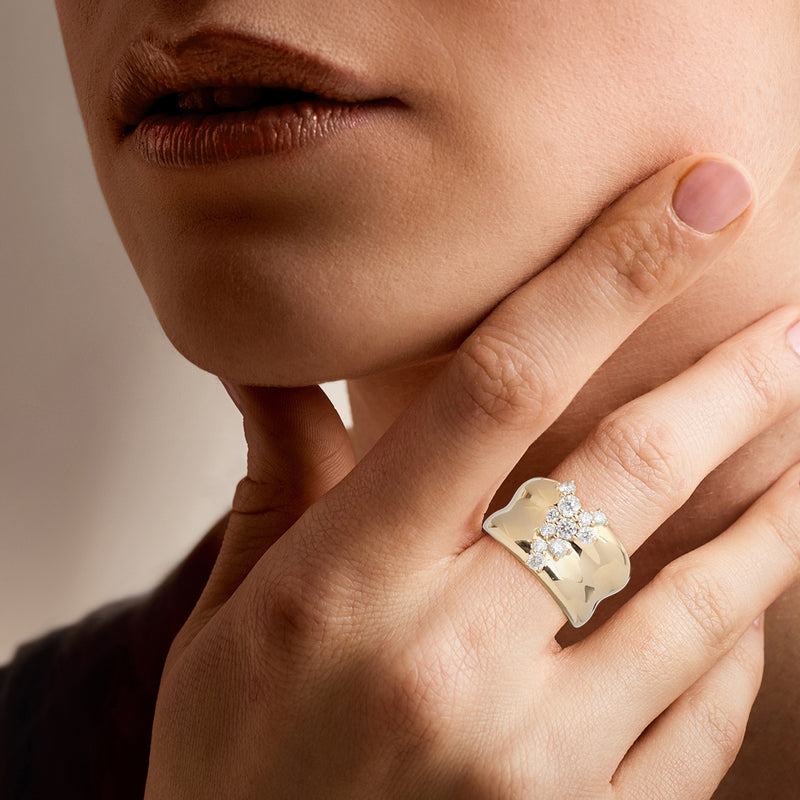 14kt yellow gold scattered-diamond ring on hand with round white diamonds