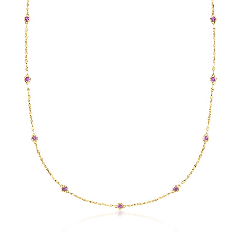 Gold amethyst station necklace with round purple bezel-set stones on a fine chain