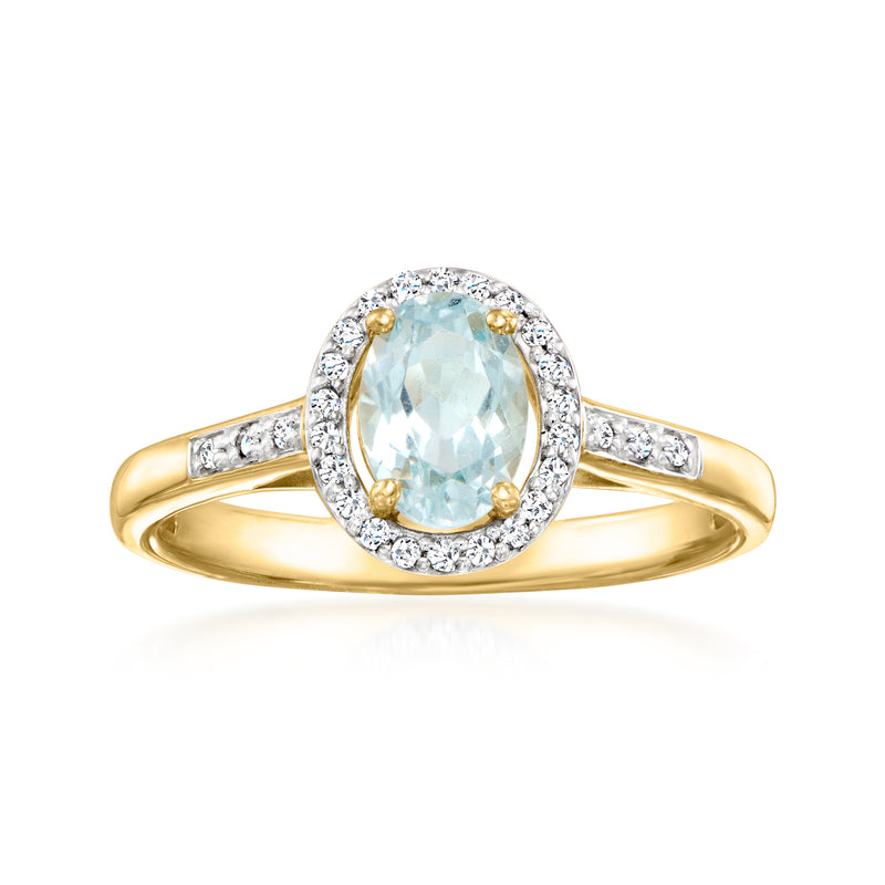 Sky blue topaz halo ring in 10kt yellow gold with diamond accents, oval center