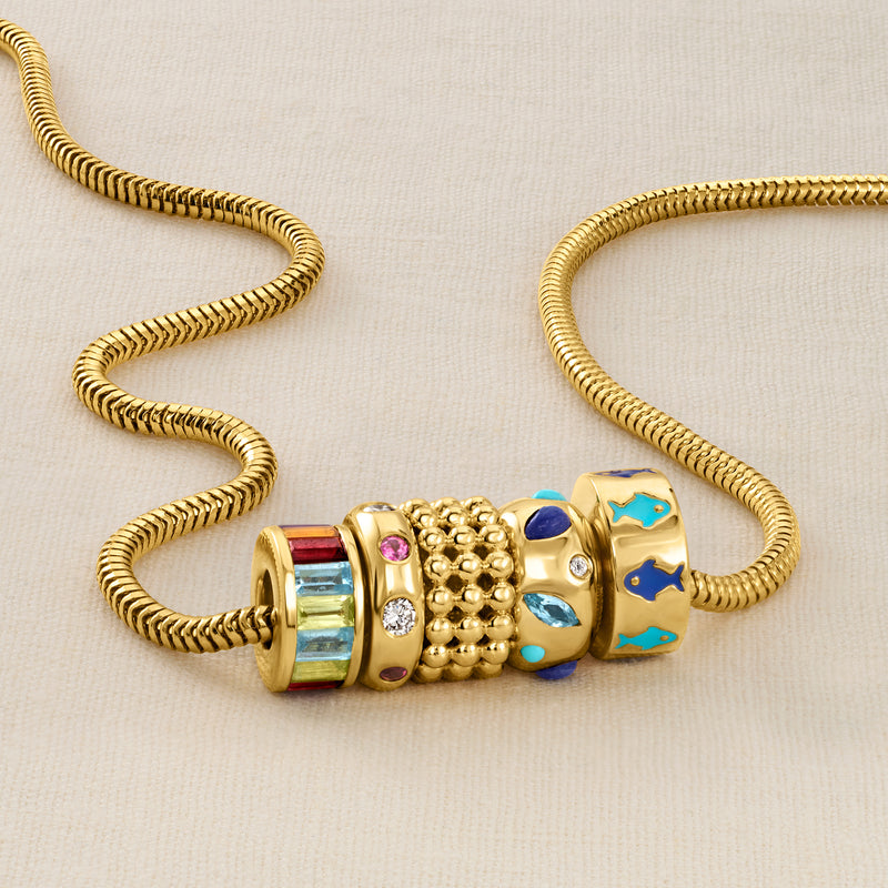 Gold bead bracelet section with colorful enamel beads and a central gold charm