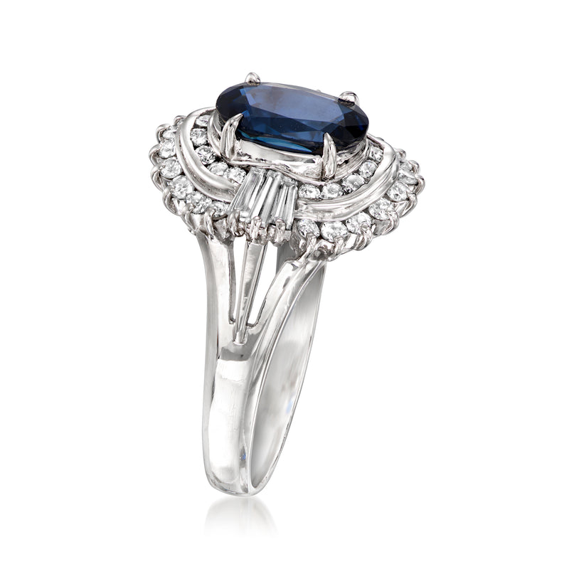 Platinum oval sapphire ring with diamond halo and prong-set blue center stone, side view