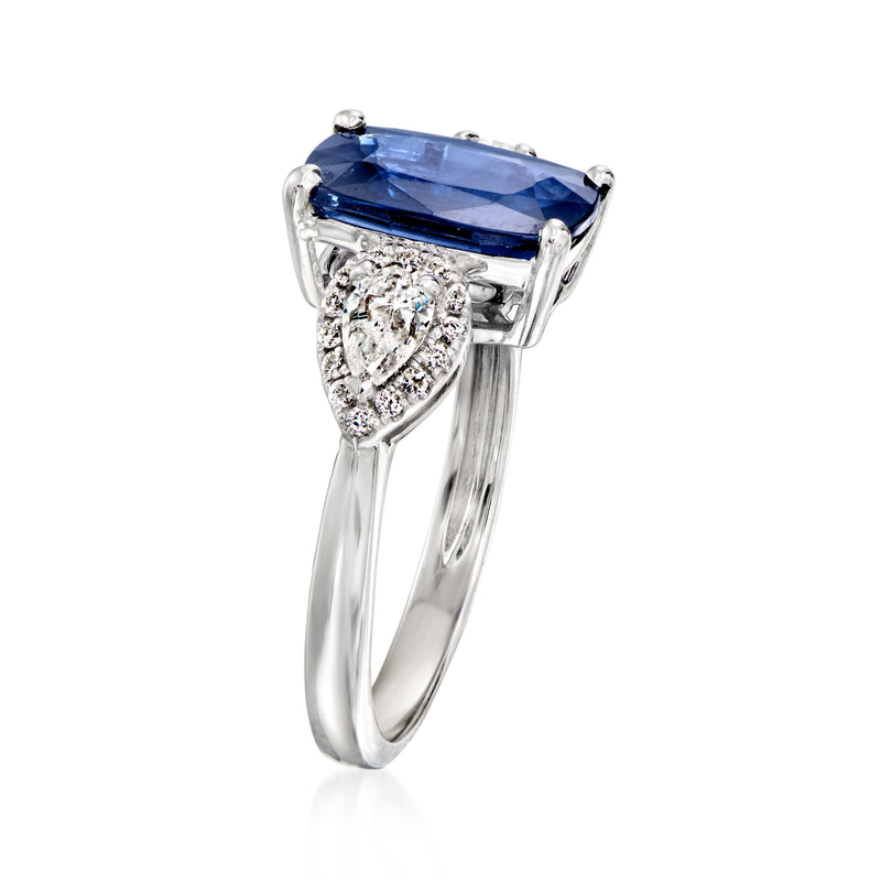 18kt white gold ring with emerald-cut blue sapphire and diamond halo side stones