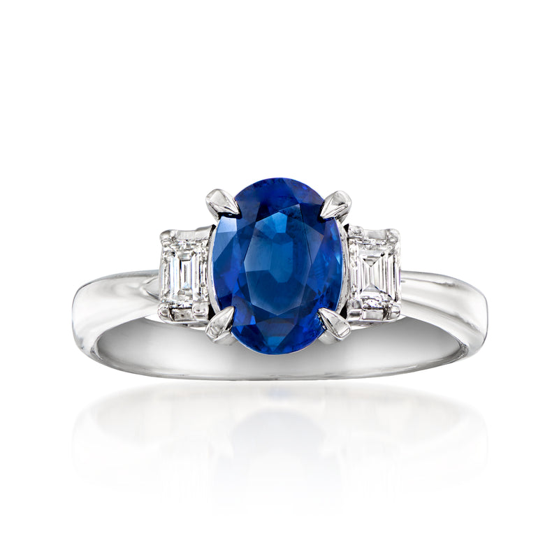 Platinum ring with oval blue sapphire and baguette diamond side settings
